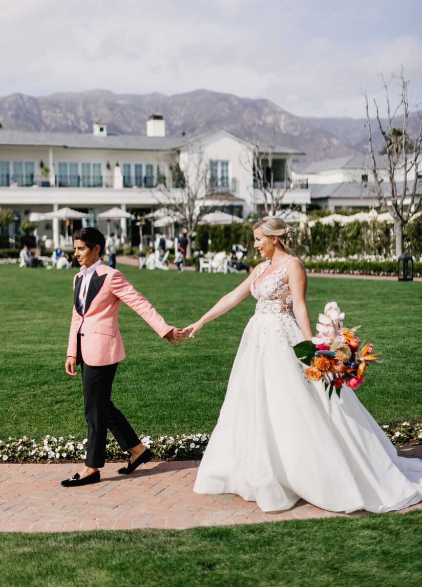 Colorful Wedding: Two brides holding hands at their wedding venue in California.