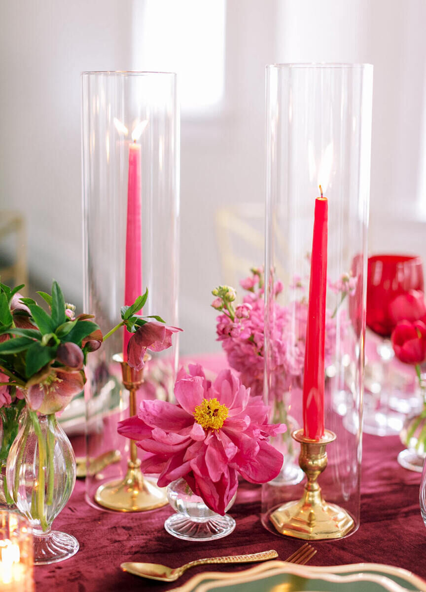 Pink taper candles and peonies were just two bold accents at the reception of a colorful wedding.