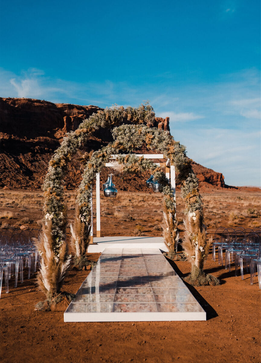 The aisle was filled with silk flowers at this desert wedding, which also boasted fresh flowers and grasses in the decor—all of which worked nicely with the natural surroundings.