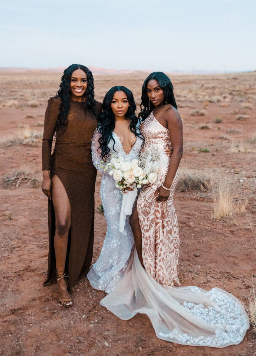 The bride and two of her guests pause for a portrait at her desert wedding.