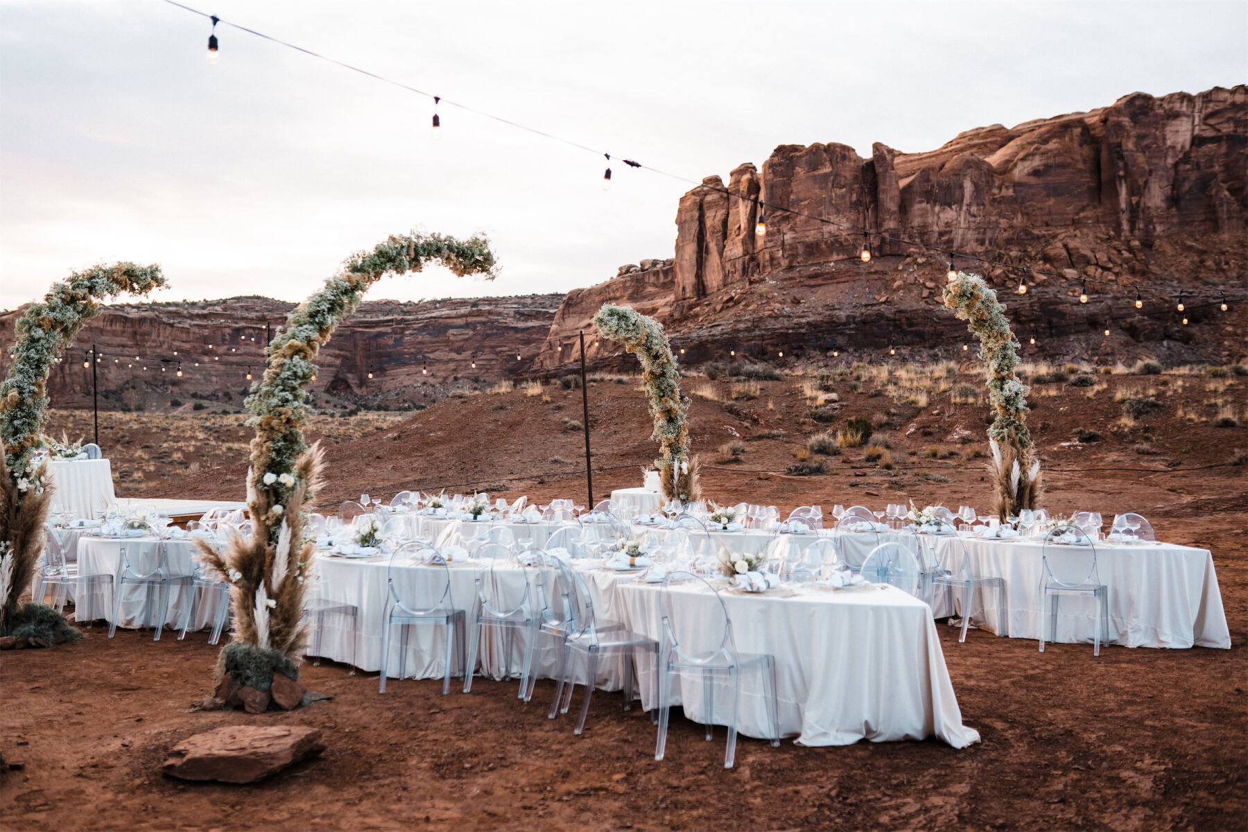 Serpentine tables added some visual interest during the open air reception at this desert wedding.