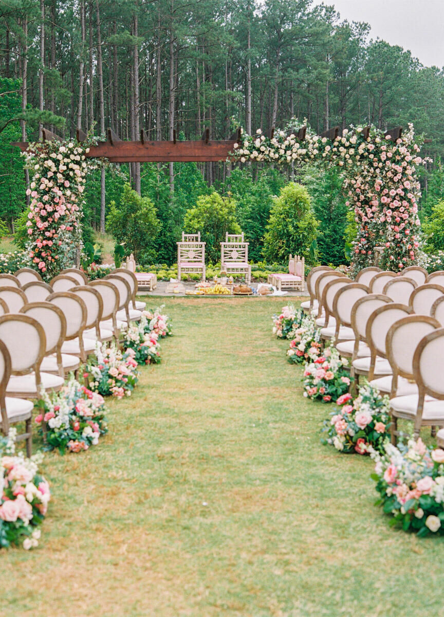 An asymmetrical mandap decorated with soft pink flowers framed the ceremony of a destination Indian wedding in North Carolina.