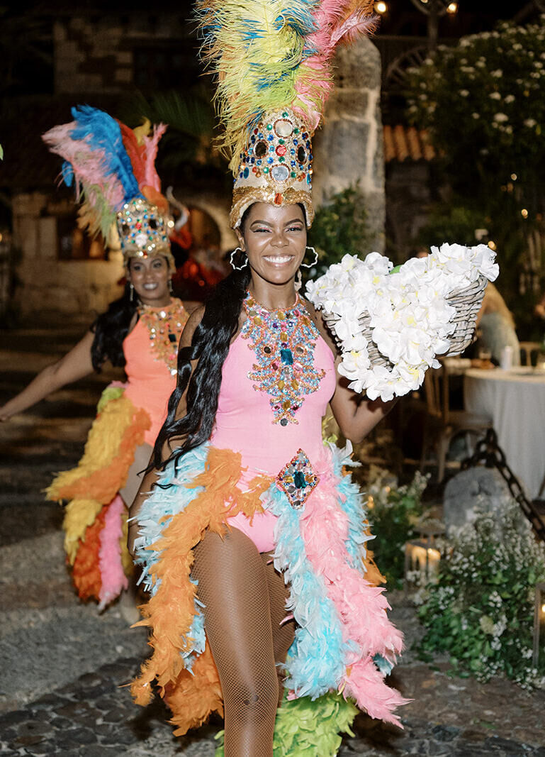 Entertainers smile as they enter la hora loca portion of a destination wedding reception in the Dominican Republic.