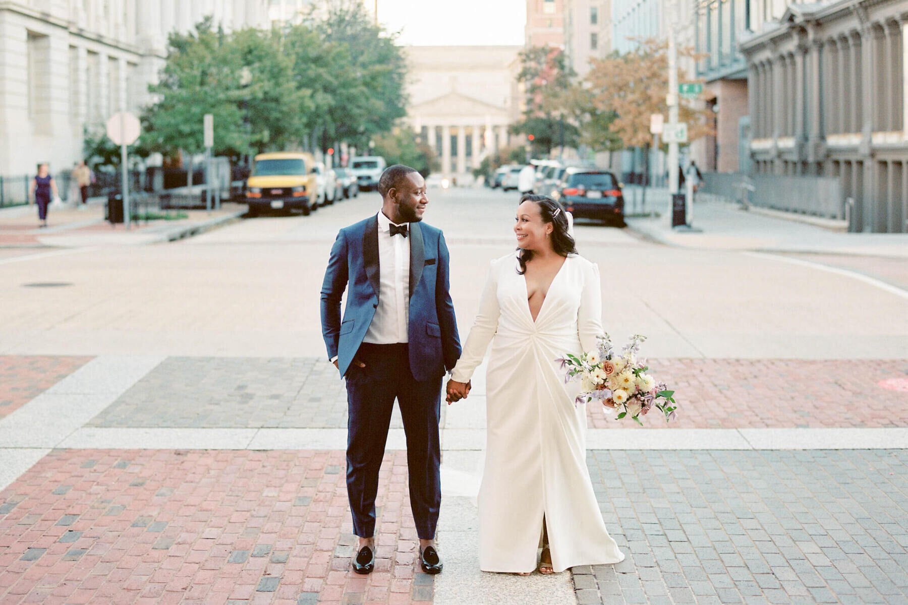 Elopement Wedding: A groom and bride make eye contact during portraits on the streets of Washington DC.
