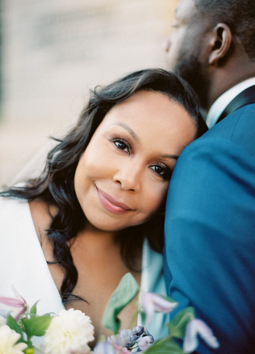 Elopement Wedding: A bride rests her head on the shoulder of her soon-to-be-husband.