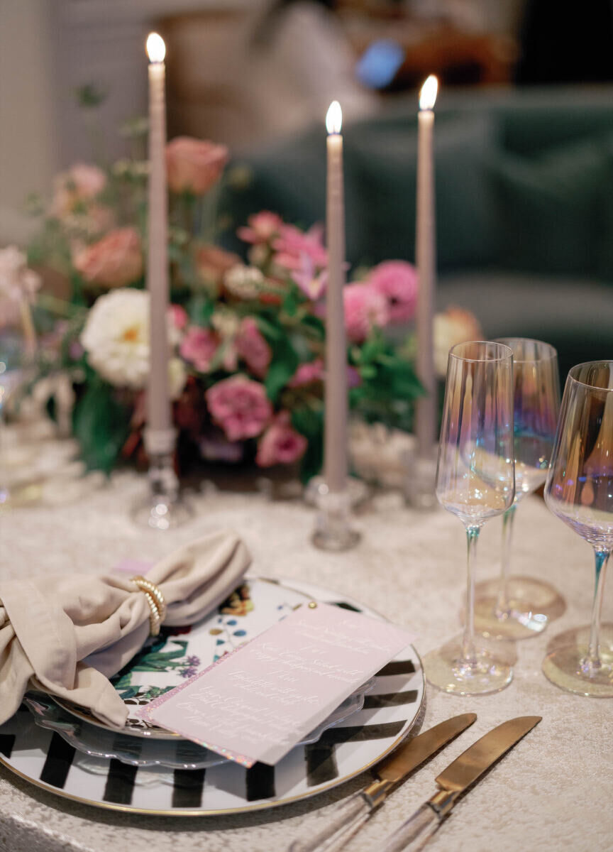 Elopement Wedding: Iridescent glassware set next to an eclectic place setting by candles and and floral arrangement.