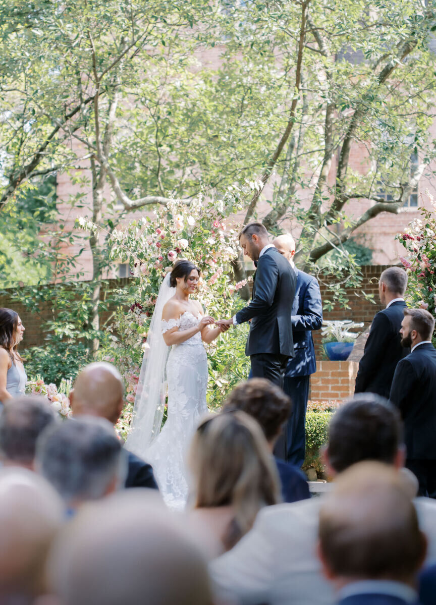 A bride and groom exchange their vows during their enchanted garden wedding ceremony.