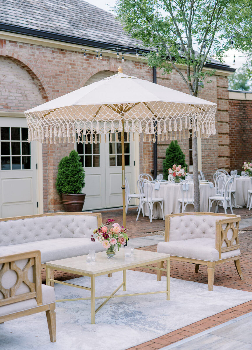 Fringed umbrellas were an accent in the lounge setup of this enchanted garden wedding.