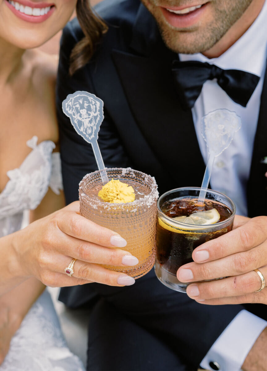 Stir sticks with the bride and groom's dog's face embellished the signature drinks at their enchanted garden wedding.