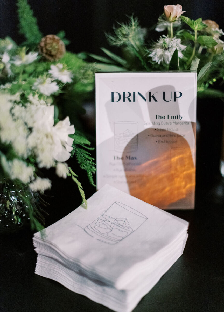 At the bar of an enchanted waterfront wedding, simple signage outlined the options while simple illustrations on cocktail napkins added a bit of personality.