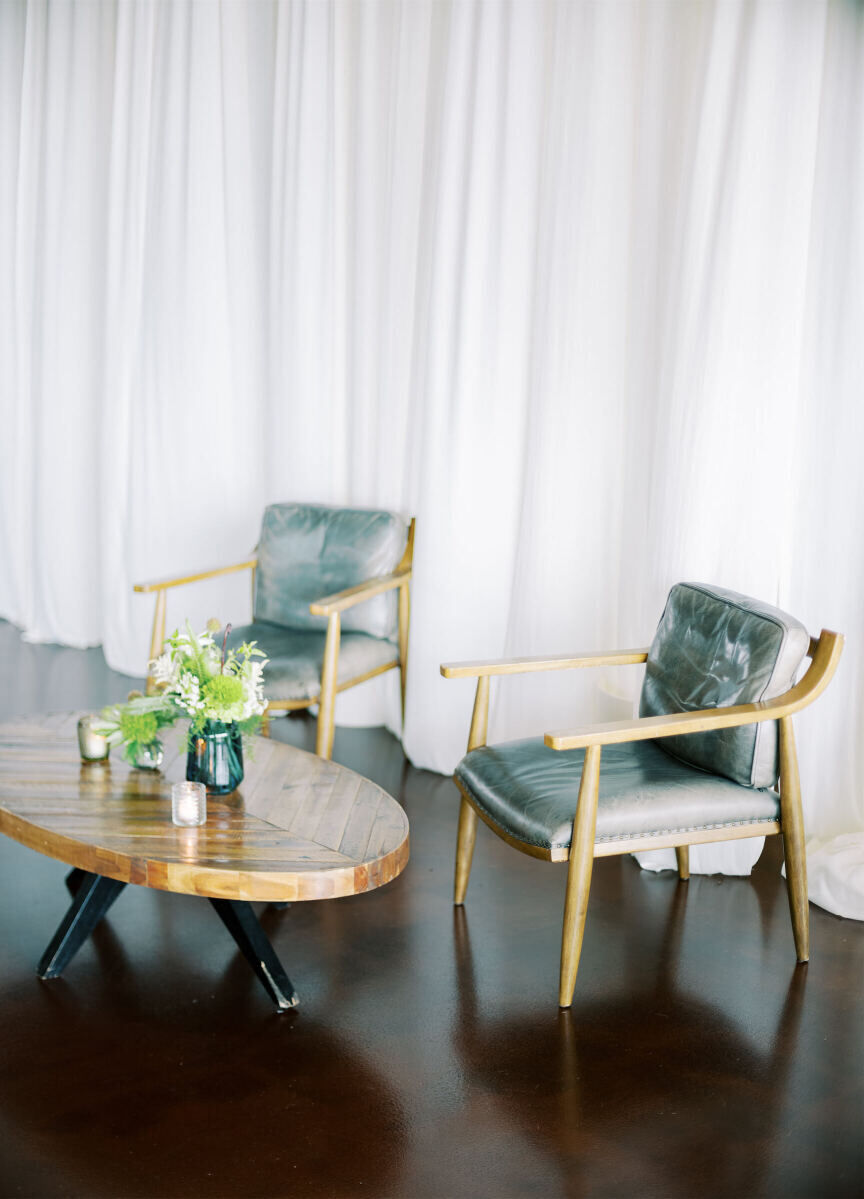 Leather and wood rental furniture composed the lounge areas of an enchanted waterfront wedding.