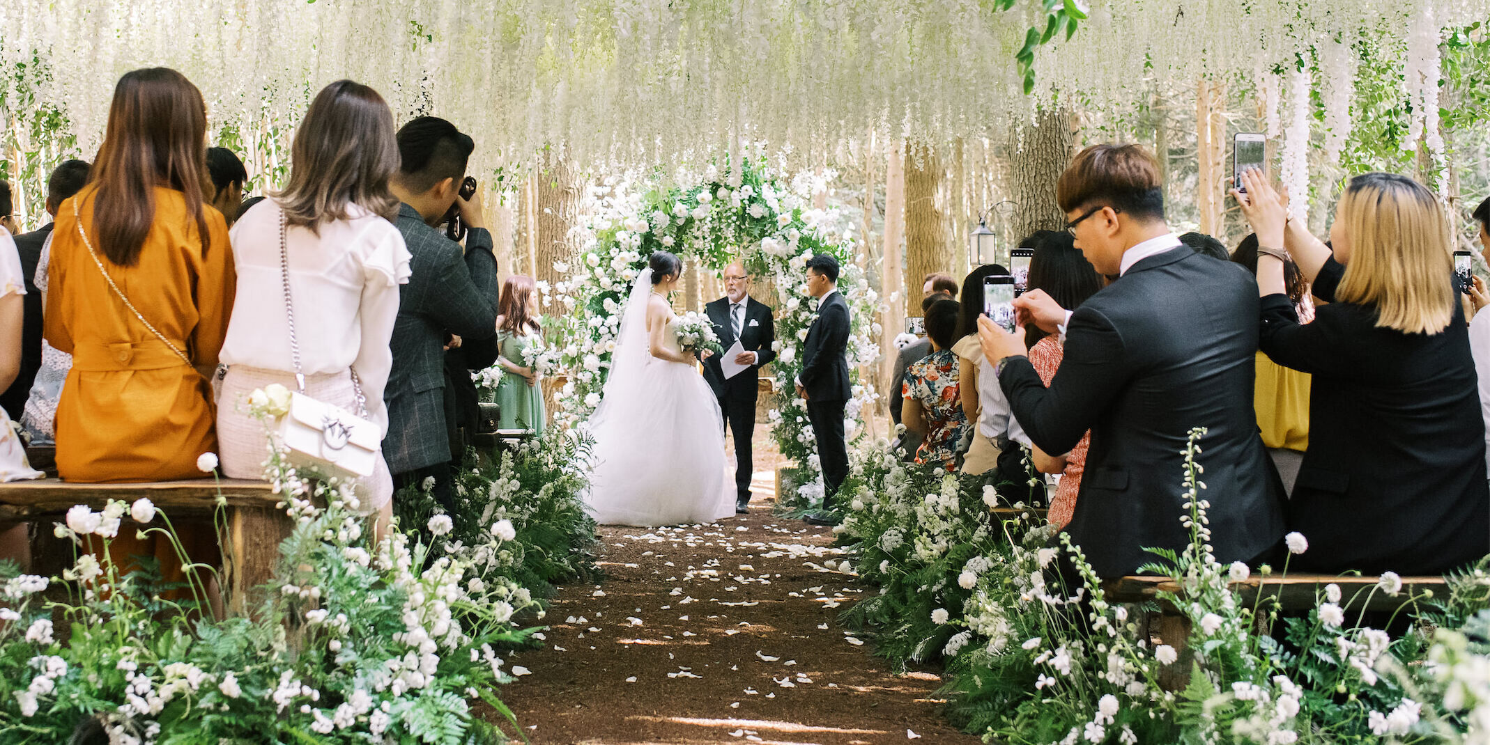 A bride and groom marry in a floral-filled forest wedding ceremony inspired by the movie Twilight's wedding scene.