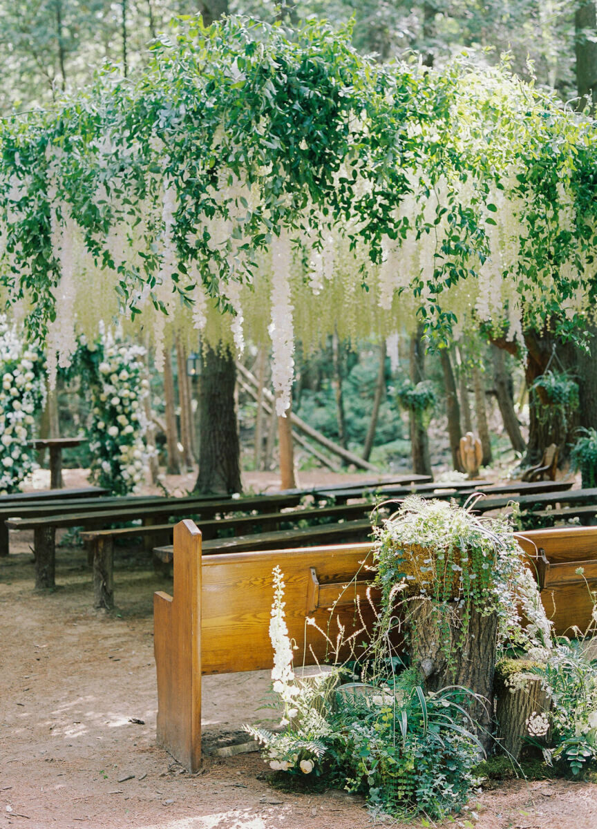 The wedding scene in Twilight inspired this forest wedding ceremony's decor, which used both fresh and faux flowers and greenery to decorate an outdoor chapel in the woods.