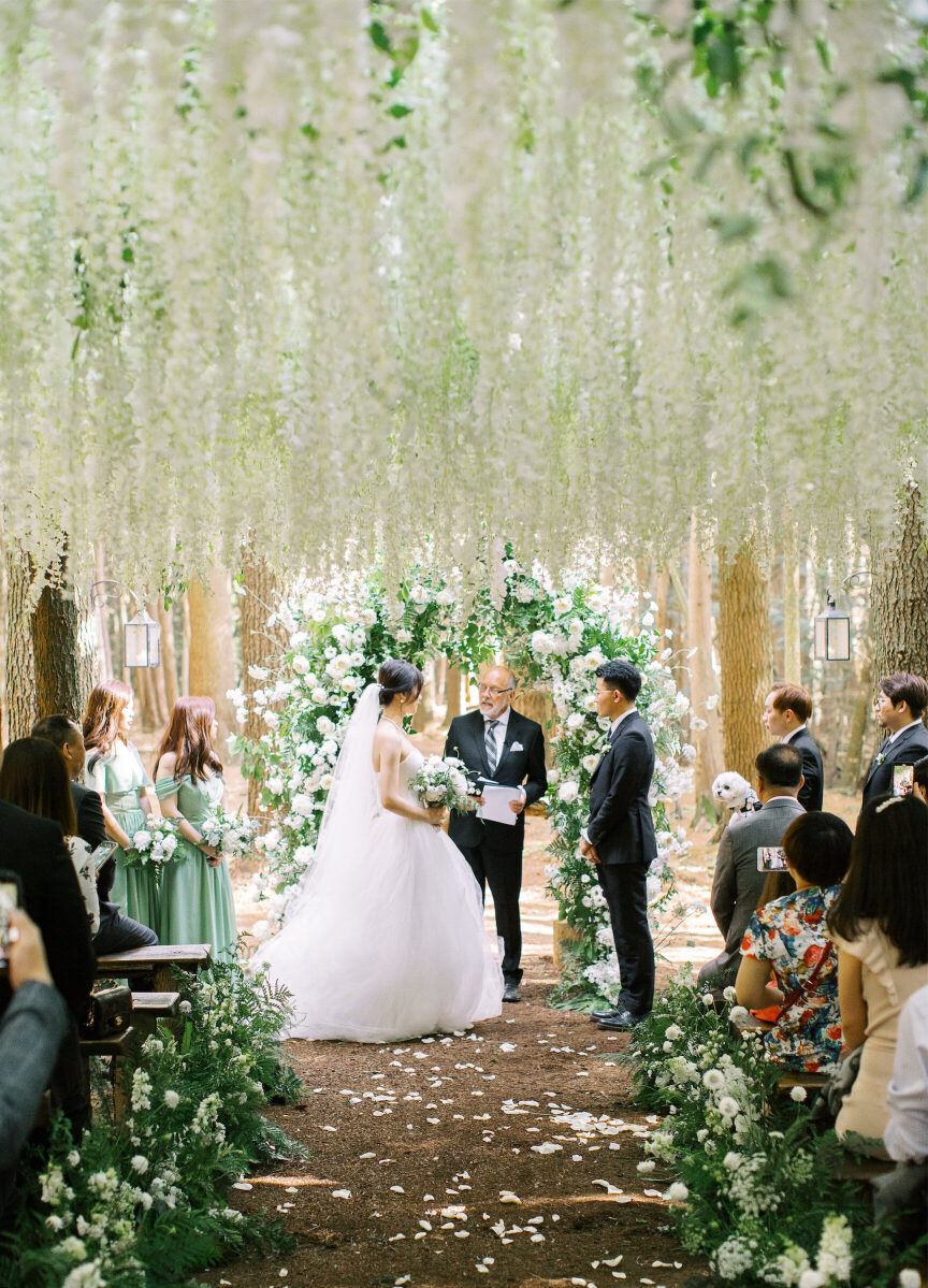 A forest wedding ceremony inspired by Bella and Edward's wedding in the movie Twilight, with tons of white flowers hanging in a canopy over the guests.