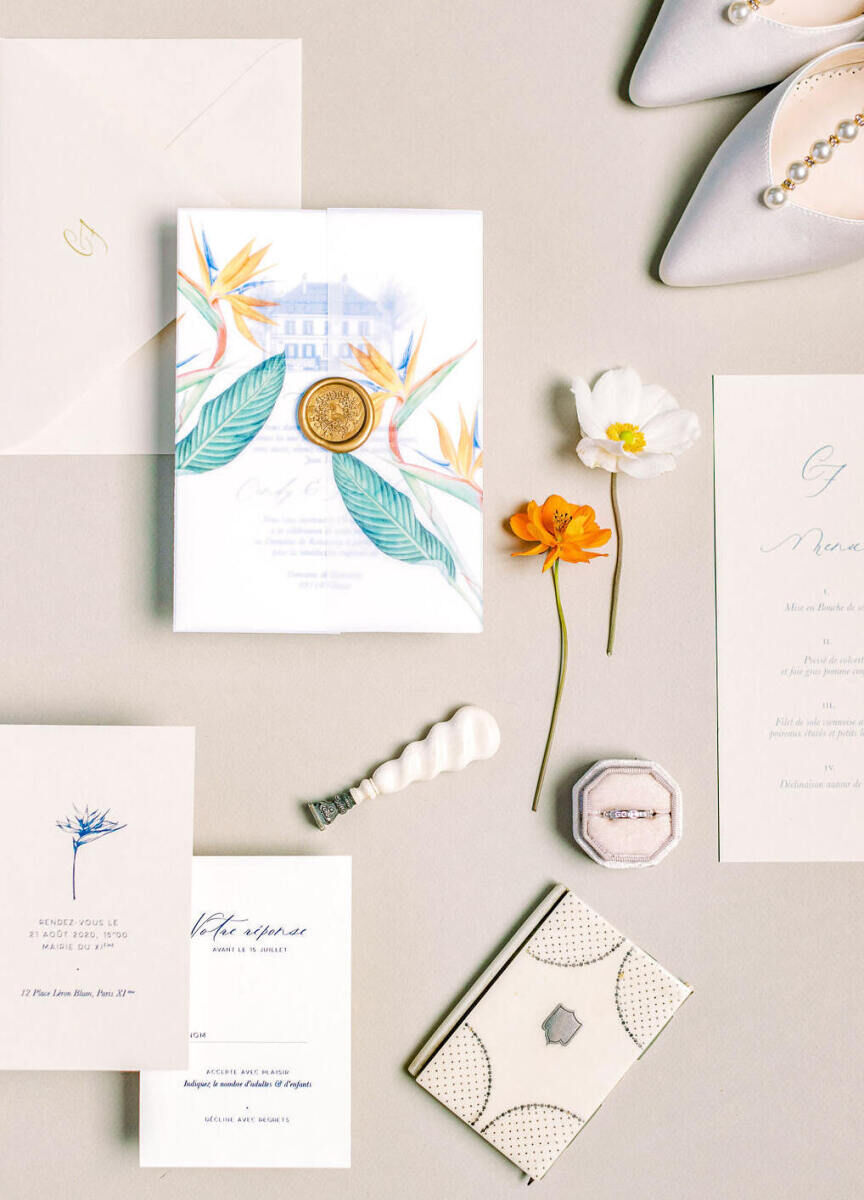 An invitation suite that fused tropical elements and the setting of the French wedding: a historic chateau.