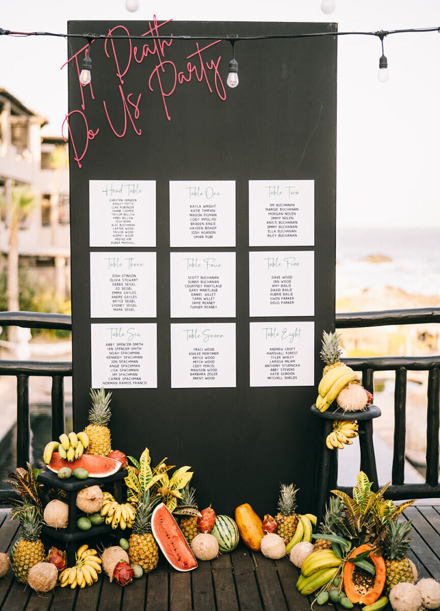 A 'Til Death Do Us Party seating chart anchored in fruit was a bold statement piece at a glam beach wedding in Cabo.