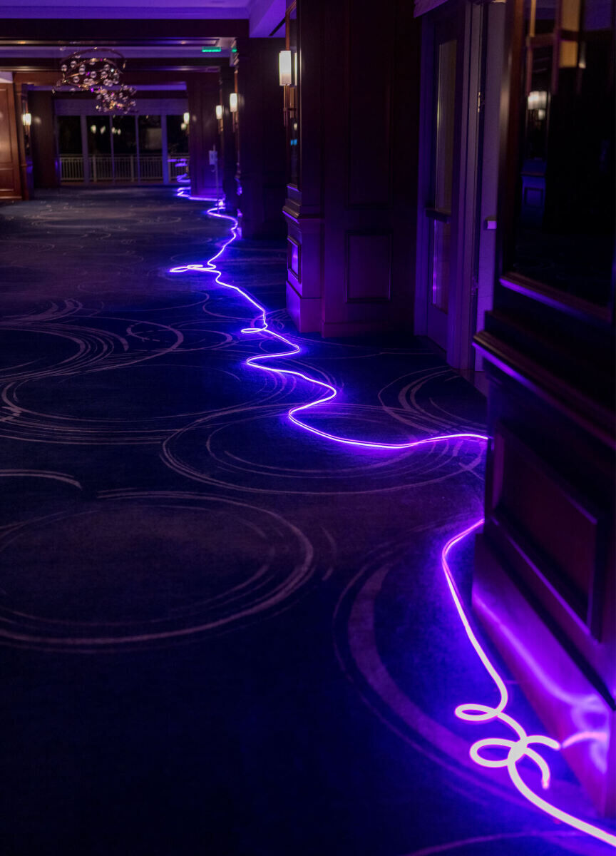 Illuminated LED rope guided the way through the hotel where a glam enchanted wedding took place.