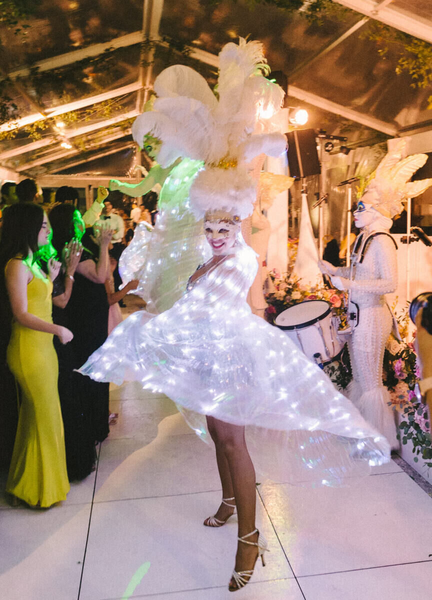 A performer wore a light-up costume during the hora loca of a glam, garden wedding reception.