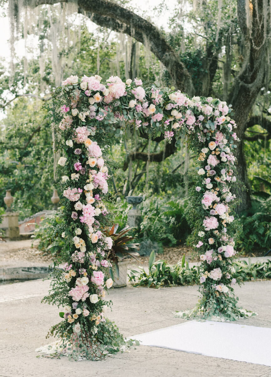 For the glam, garden wedding ceremony, an arch covered in pink flowers was created.