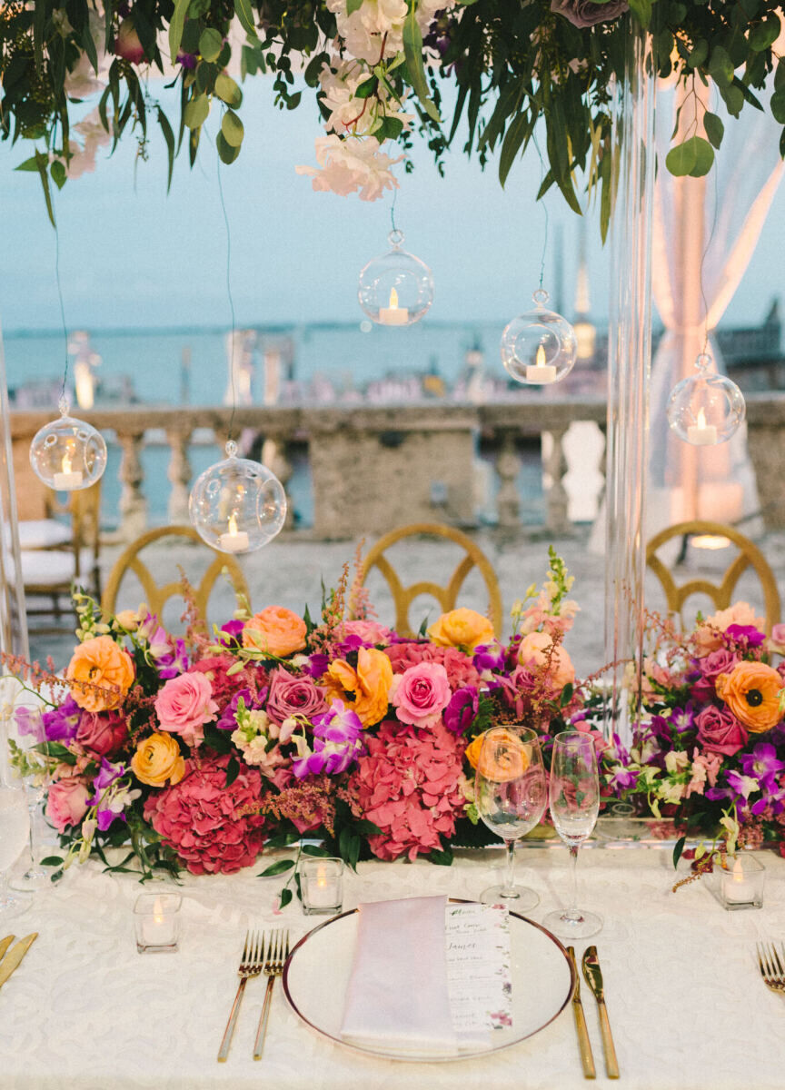 Colorful blooms pop at a glam, garden wedding reception.