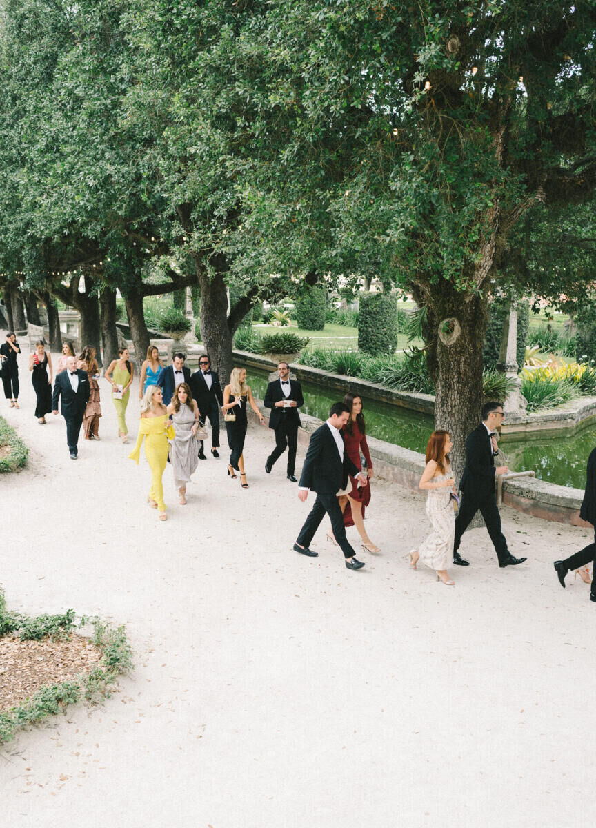 Guests move from one part of Vizcaya Museum & Gardens to another for a glam, garden wedding reception.