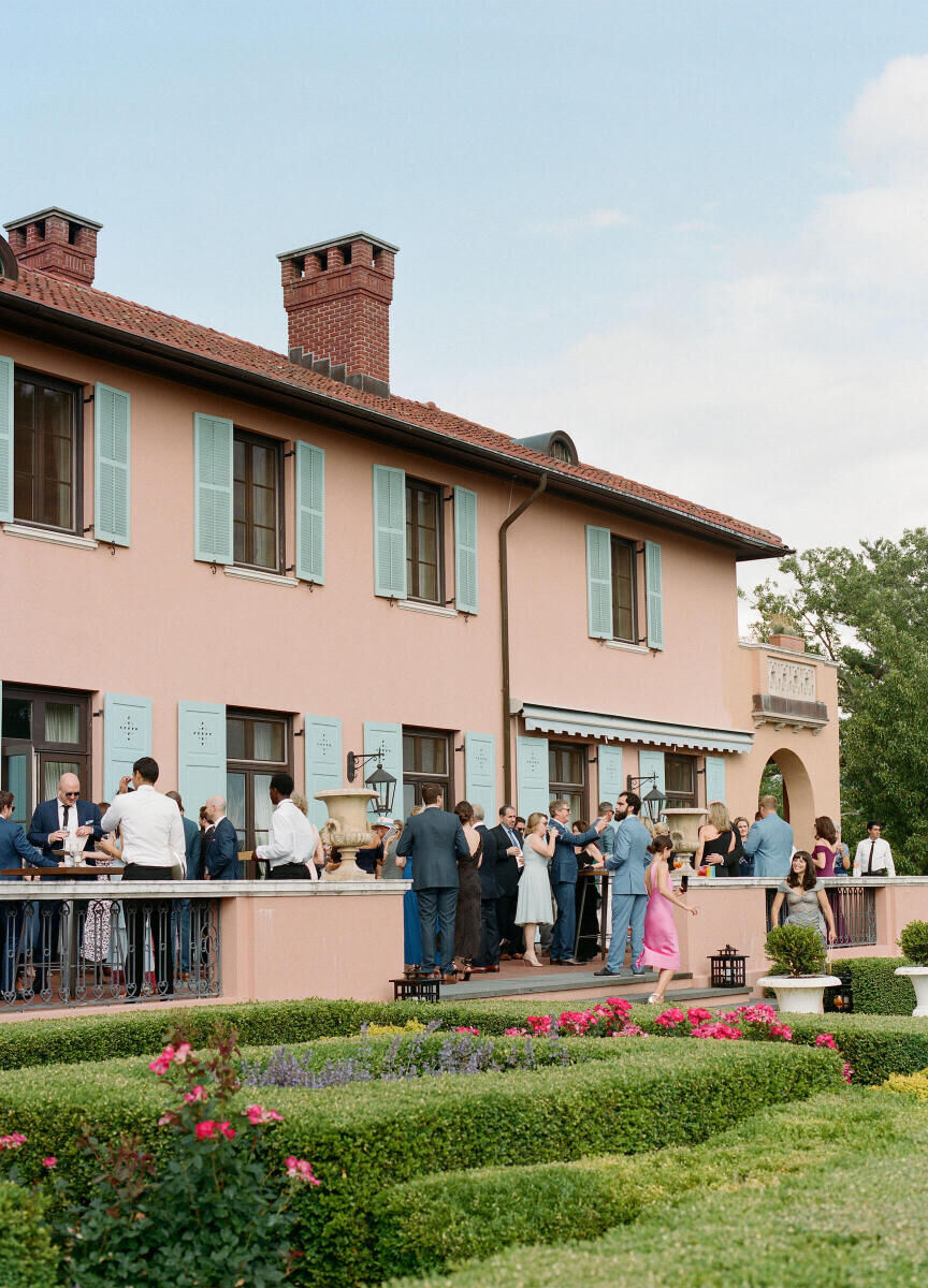 The cocktail hour of a Glenmere Mansion wedding, on the terrace overlooking one of the gardens.