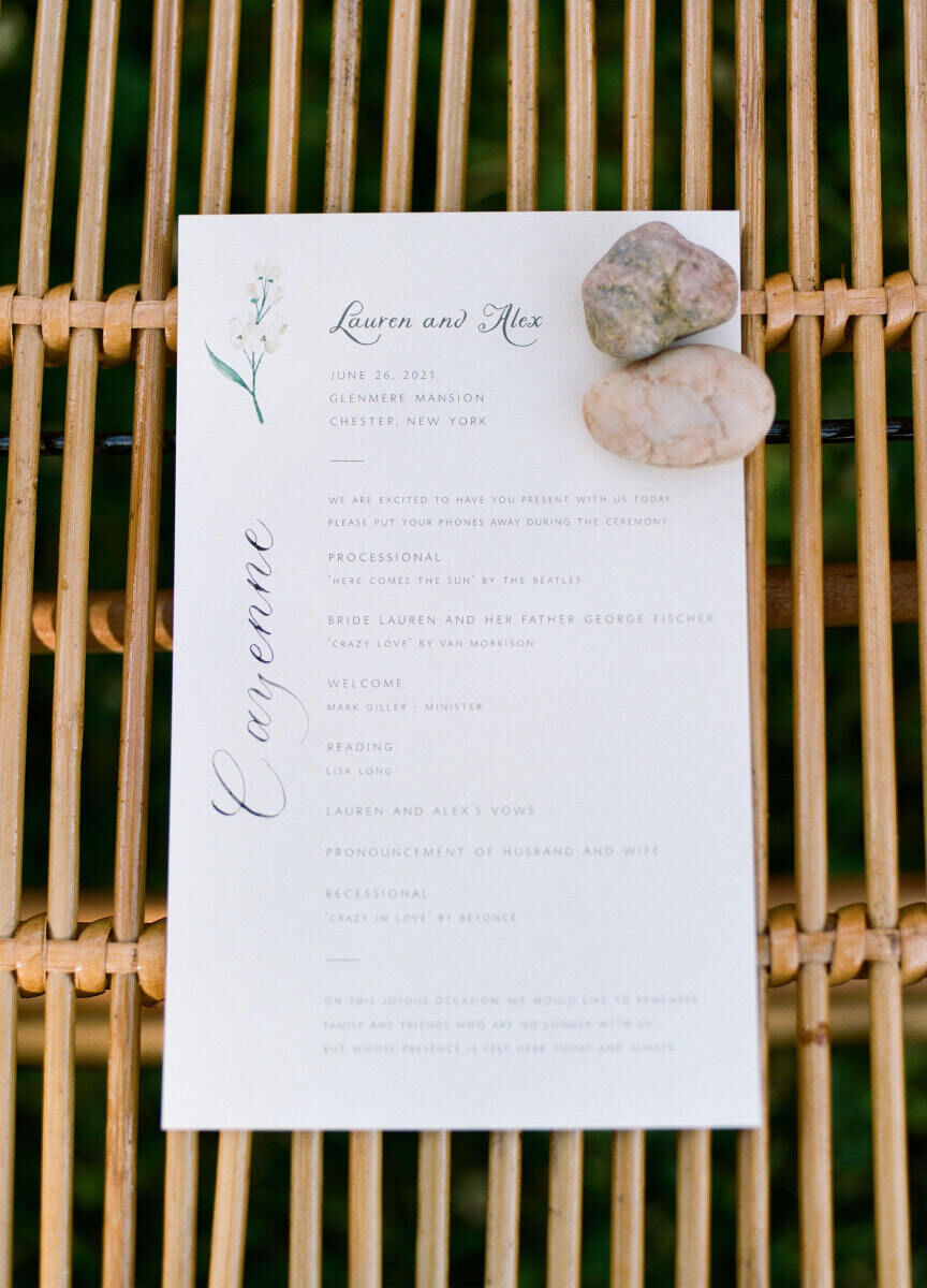 A ceremony program for a printed on hand-torn paper, with a floral illustration and hand calligraphed accents.