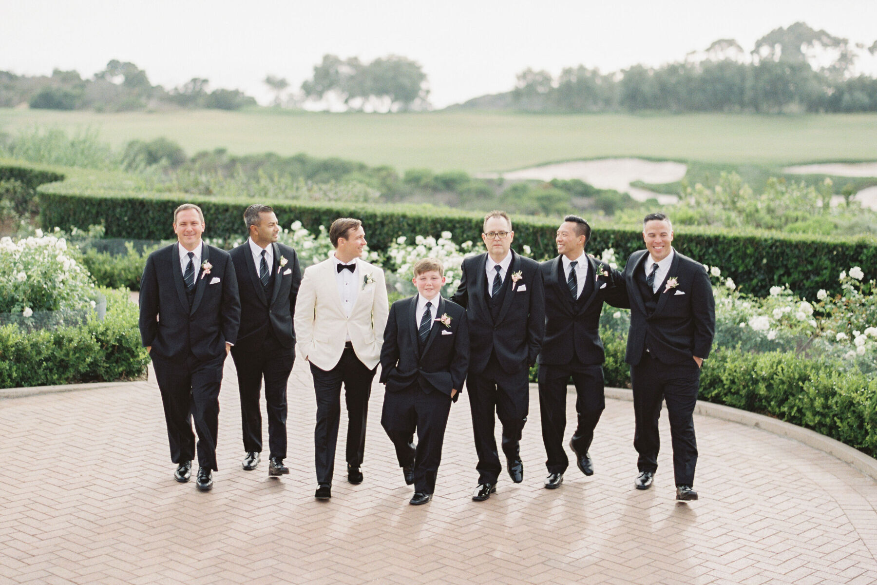 Golf Course Wedding Venues: A groom posing with his wedding party.