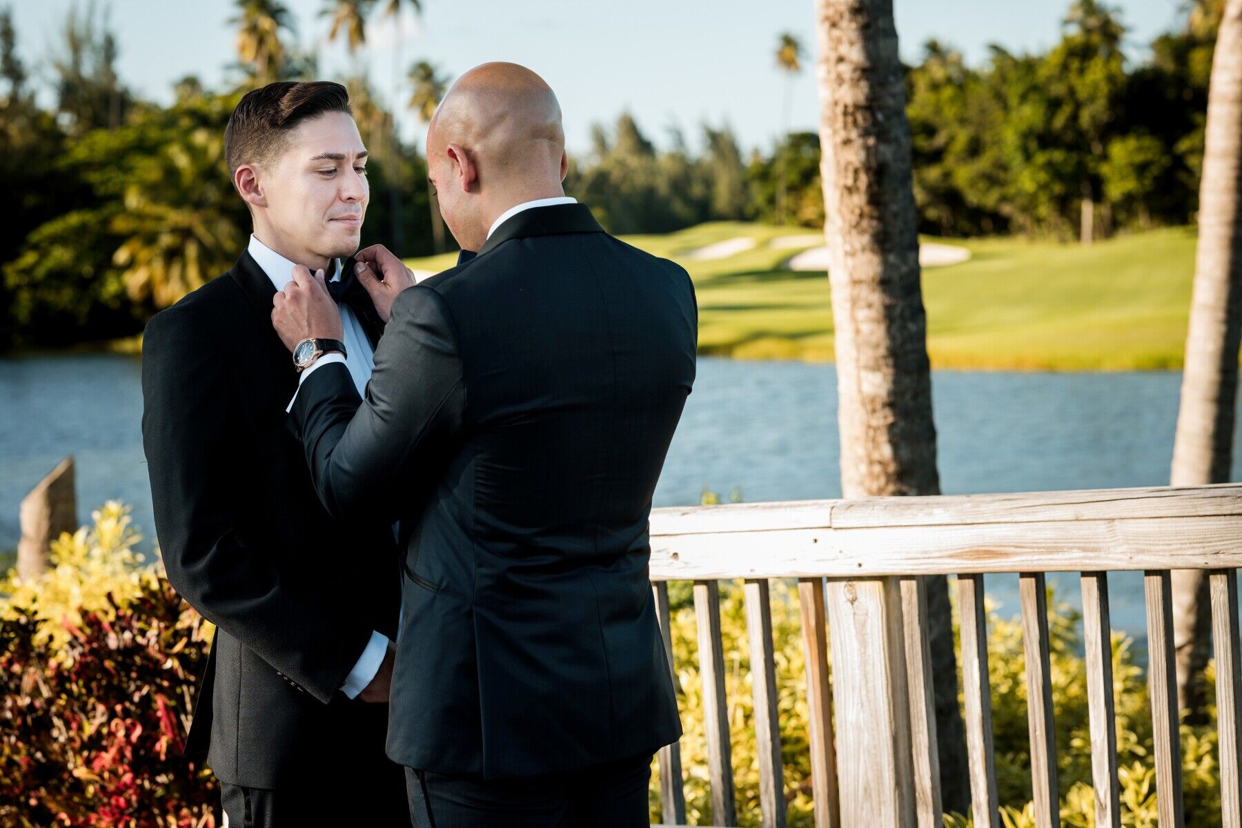 Golf Course Wedding Venues: A groom adjusts his groom's tie on their wedding day.