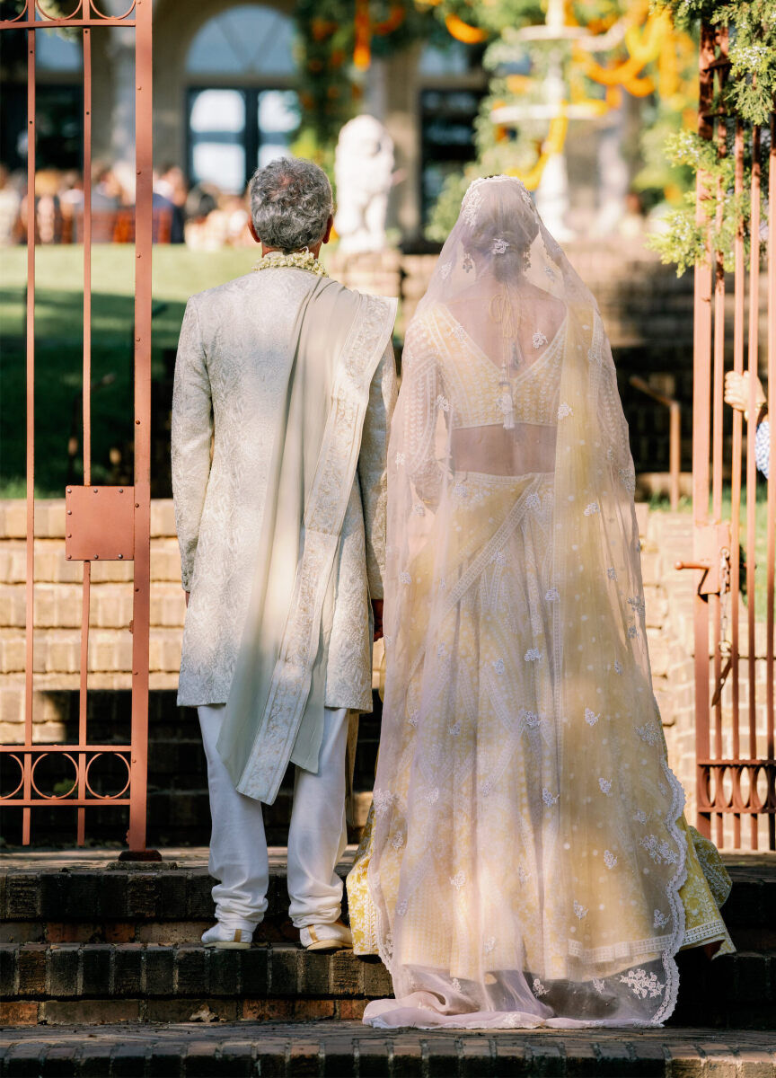 A bride and her father wait to process down the aisle at her Indian fusion wedding in Austin.