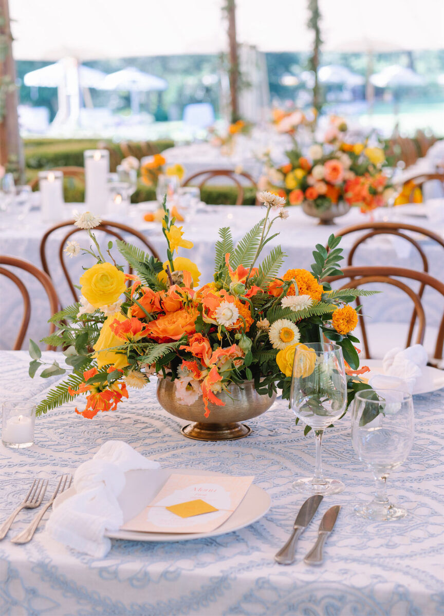 The centerpieces at an Indian fusion wedding used citrus-hued flowers and actual fruit.