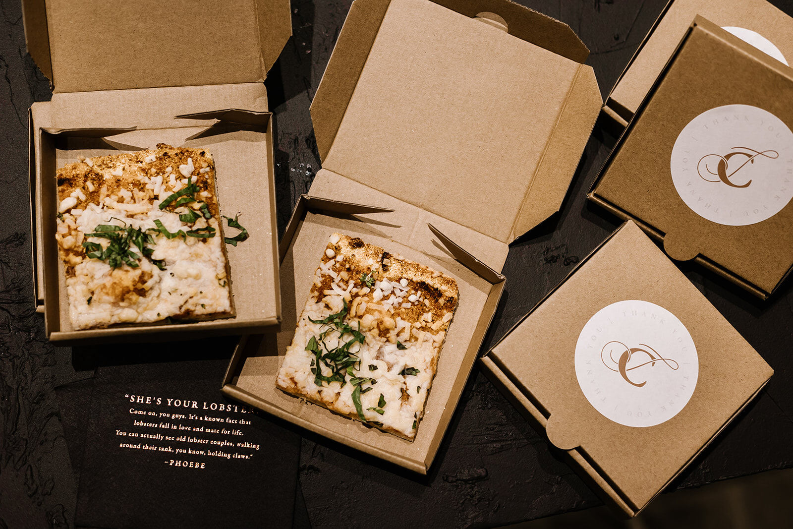 Mini boxes of pizza, with the couple's monogram on a sticker on the lids, made the rounds late-night at an industrial wedding.