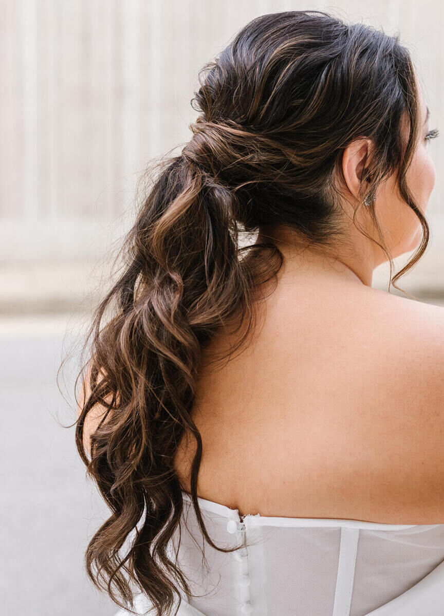 For her industrial wedding in Baltimore, the bride opted for a low ponytail with loose waves.