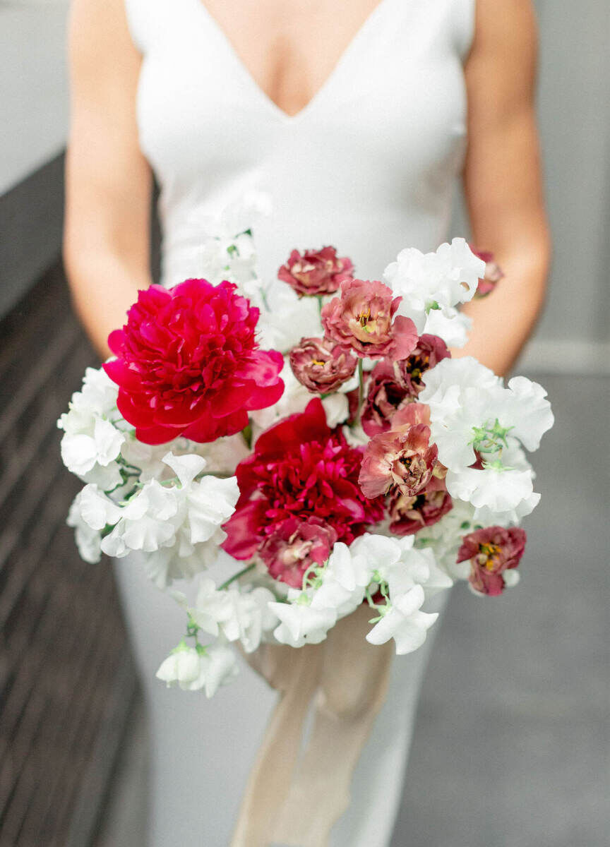 Pink peonies and white sweet peas were the main components of this bridal bouquet.
