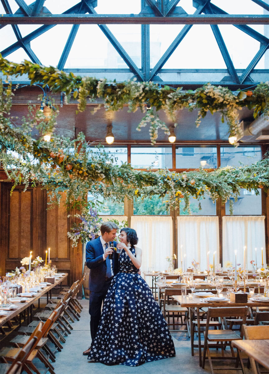 Industrial Wedding Venues: A bride and groom toasting in Brooklyn Winery.