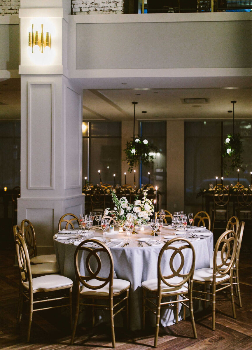 Industrial Wedding Venues: A wedding reception set-up with tall columns and a white-tableclothed table.