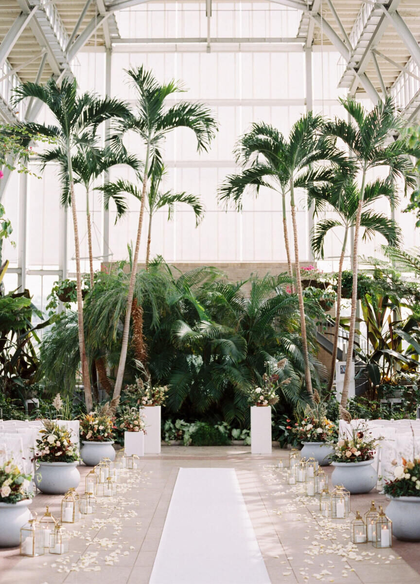 Industrial Wedding Venues: A ceremony and aisle set-up with lots of flora and fauna at The Jewel Box.