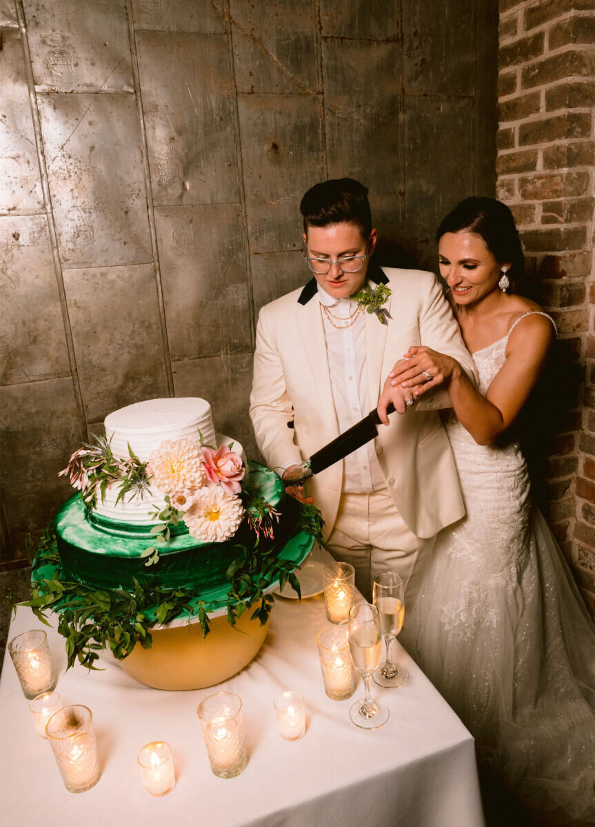 Industrial Wedding Venues: Two newlyweds cutting into their wedding cake together at Capulet.
