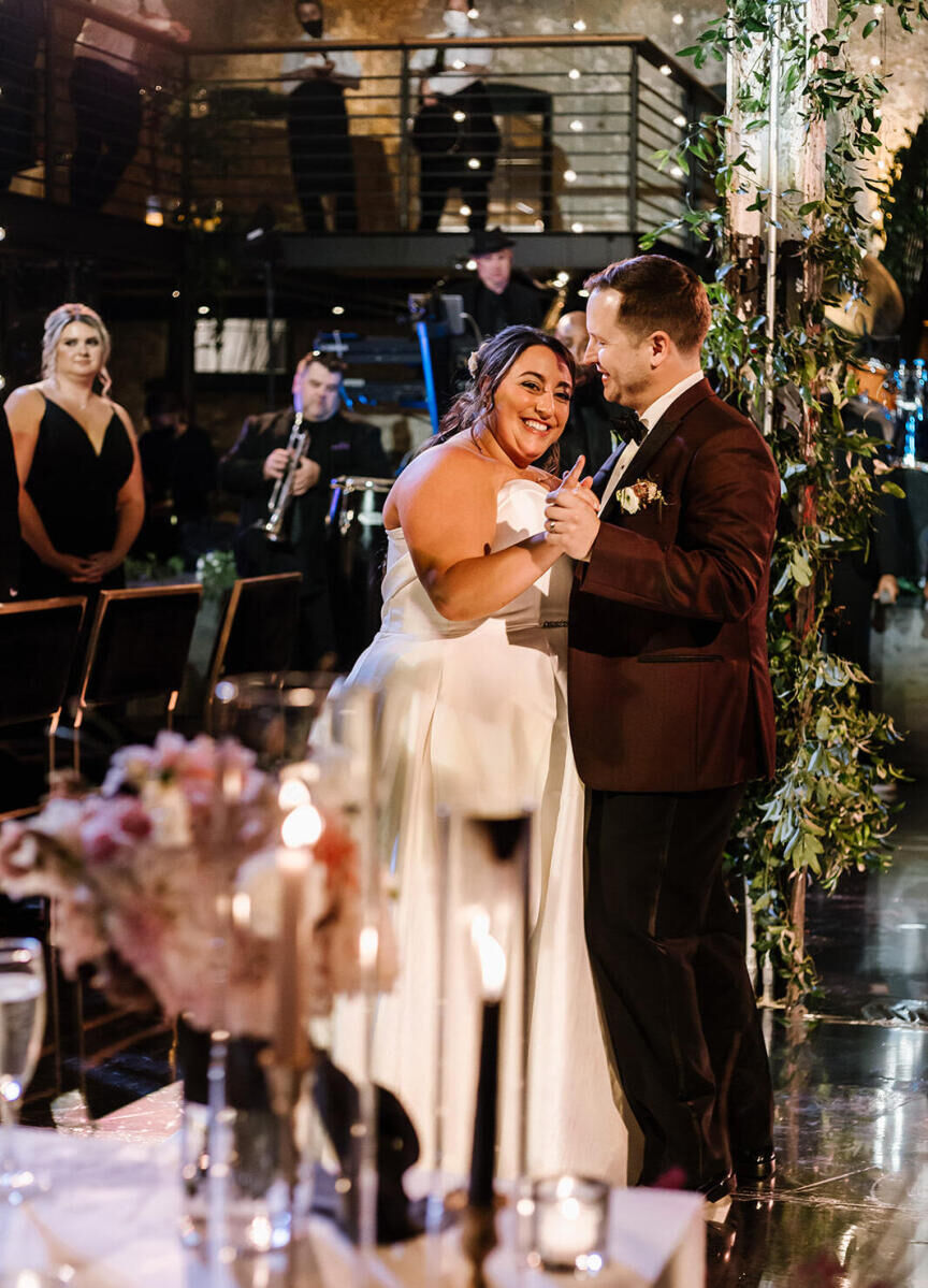 Industrial Wedding Venues: A bride and groom smiling and slow-dancing together at The Winslow.