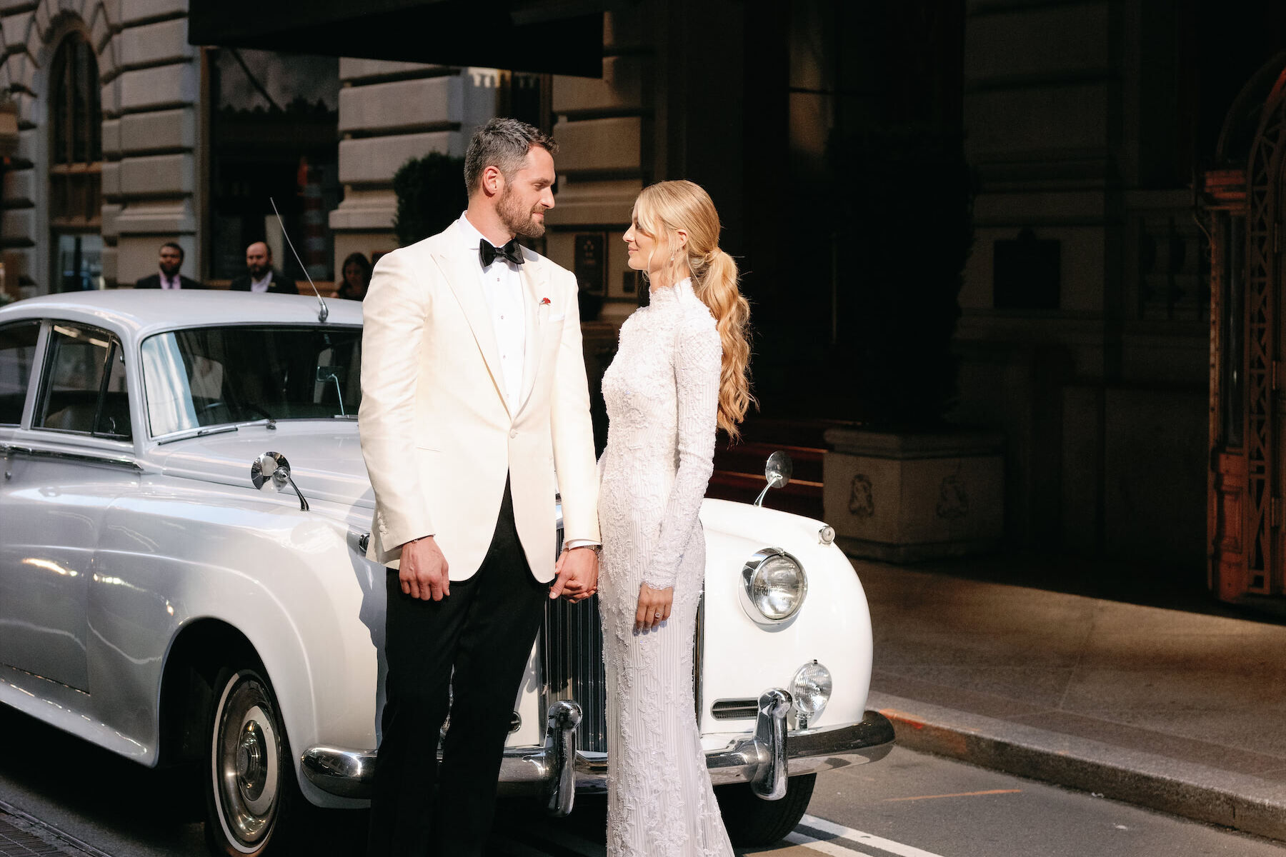 Kate Bock Kevin Love Wedding: Kevin Love and Kate Bock posing in front of a vintage car just before their wedding ceremony.
