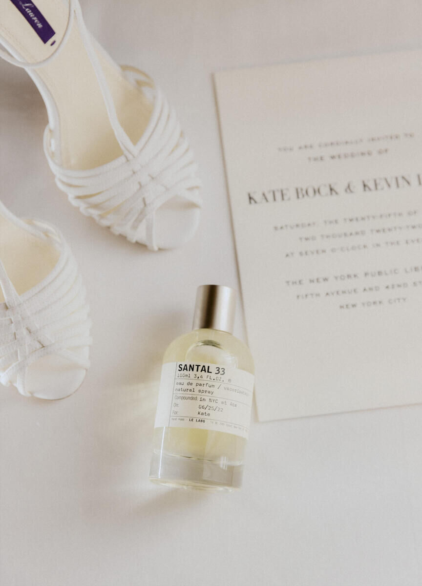 Kate Bock Kevin Love Wedding: A flat lay of model Kate Bock's shoes, perfume and wedding invitation.