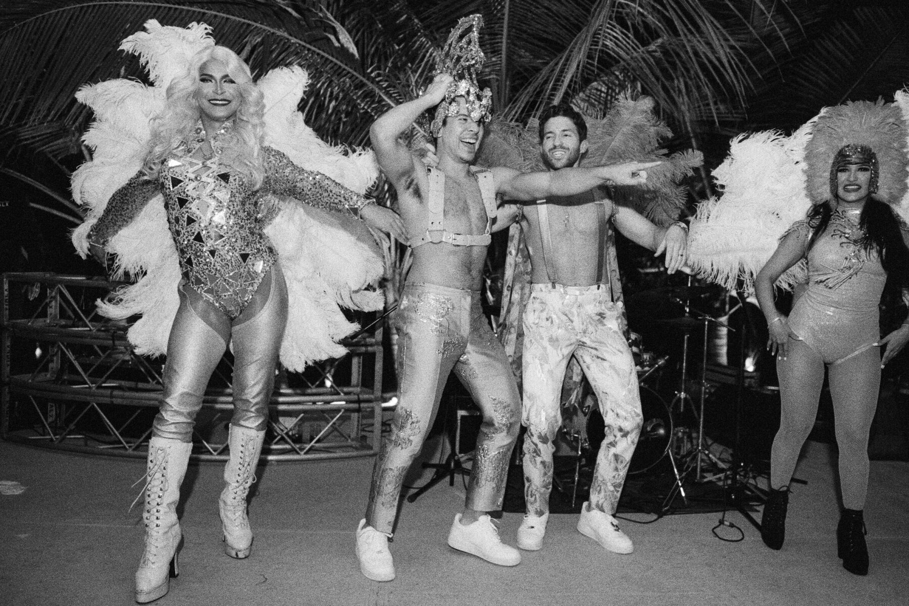 Latinx Heritage: Two grooms dancing during their wedding reception with drag queen performers.