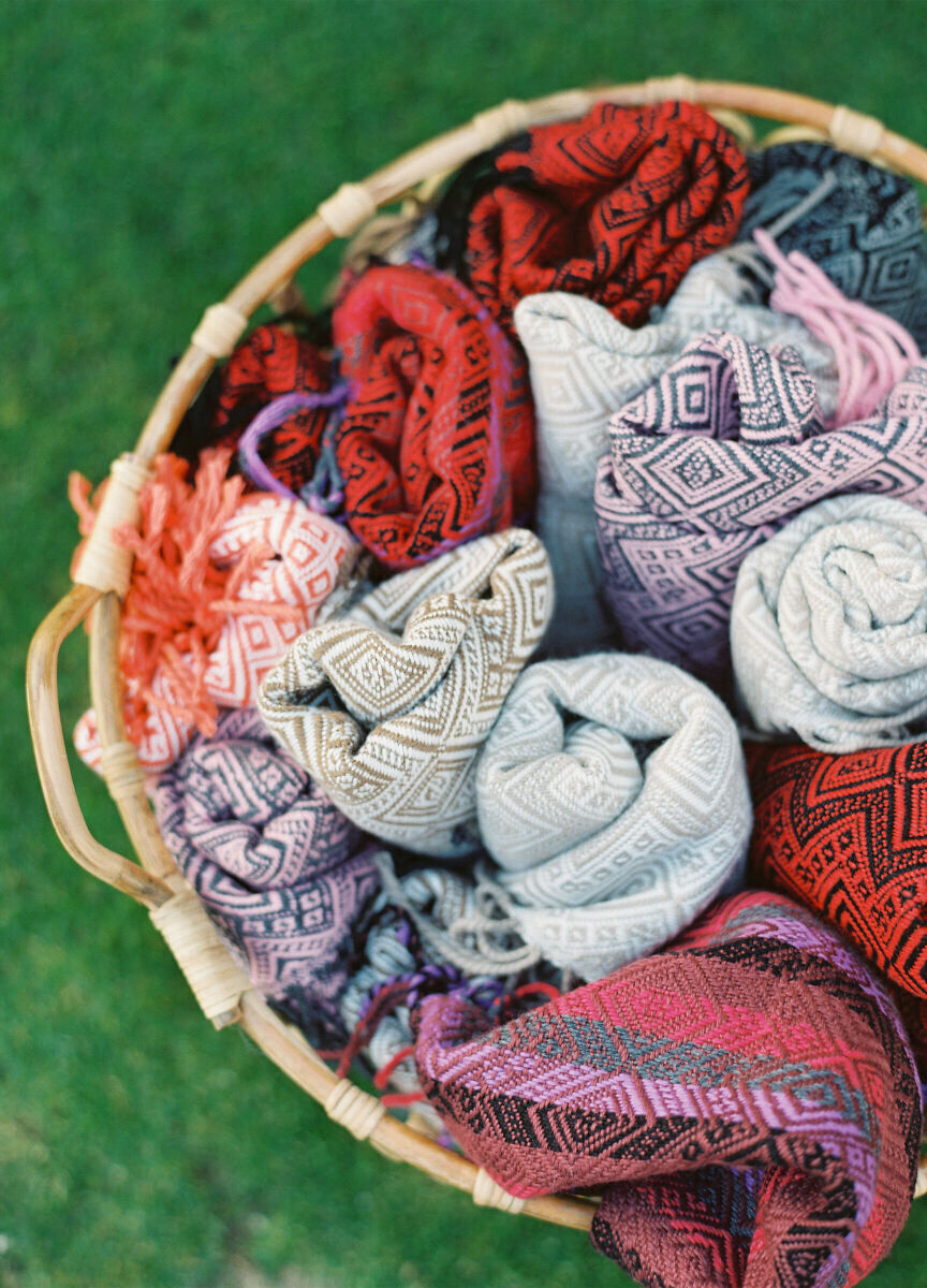 Latinx Heritage: Multicolored shawls from Lima, Peru, in a woven basket.