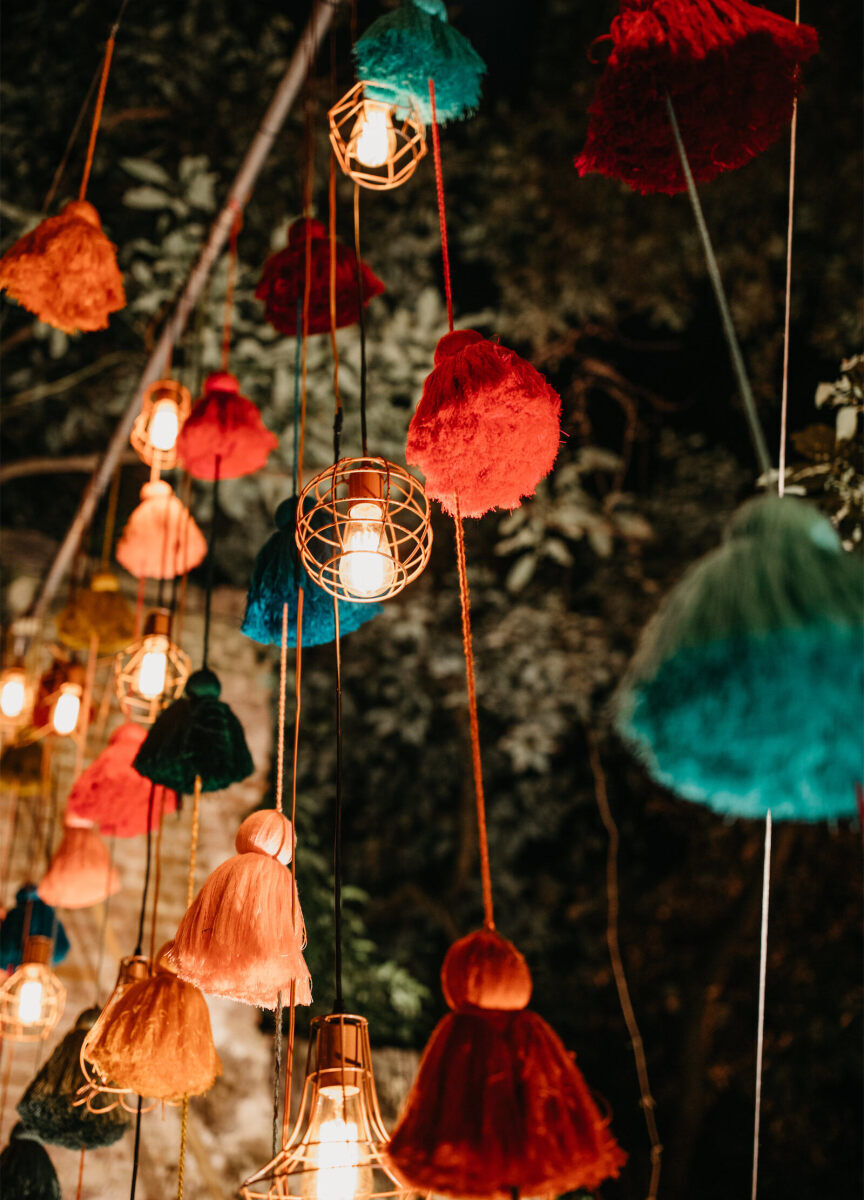 Latinx Heritage: Strings of multi-colored pom-poms hanging from the ceiling.