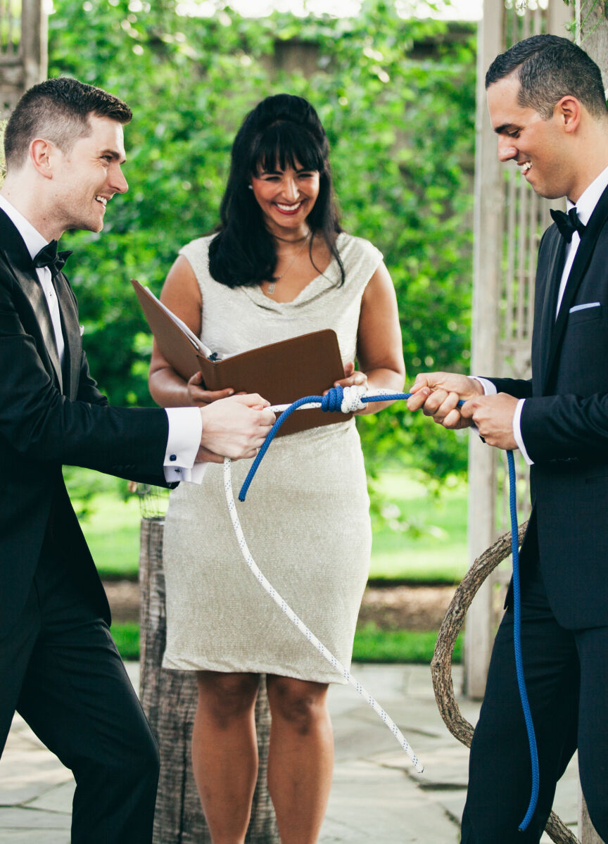 LGBTQ Wedding Ideas: A couple pulling on a rope during their wedding ceremony.