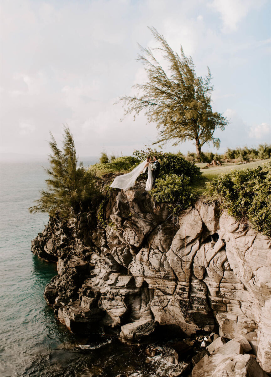 Marriott Weddings: A wedding couple posing for a portrait on a cliffside area in Hawaii.