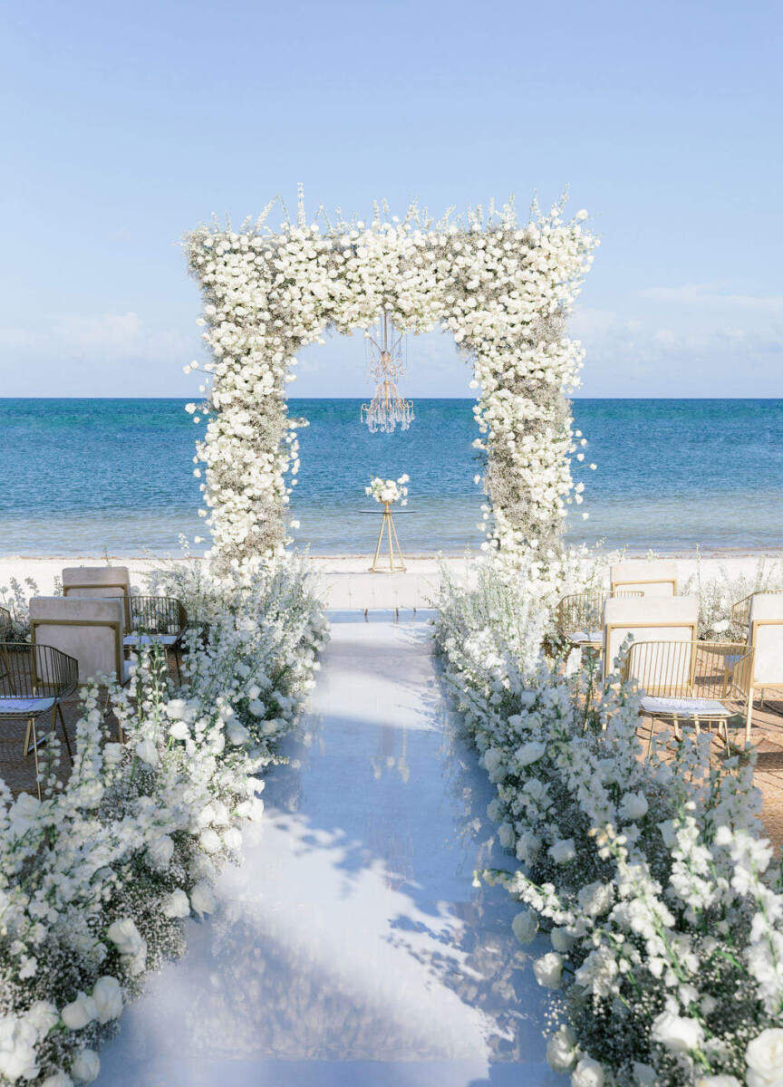 Mexican wedding: all-white beach wedding ceremony overlooking the ocean