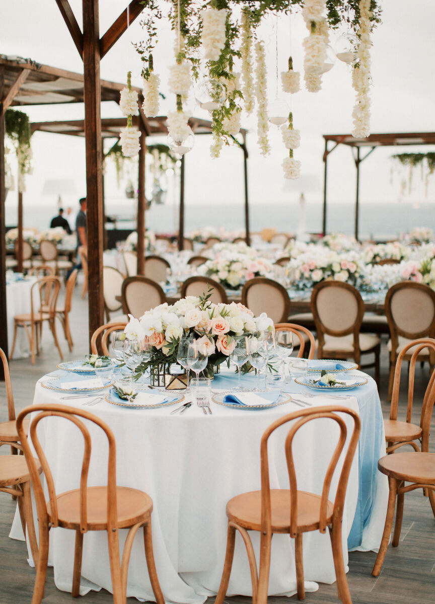 Mexican wedding: neutral wedding reception featuring blue table runners, and pink and white centerpieces