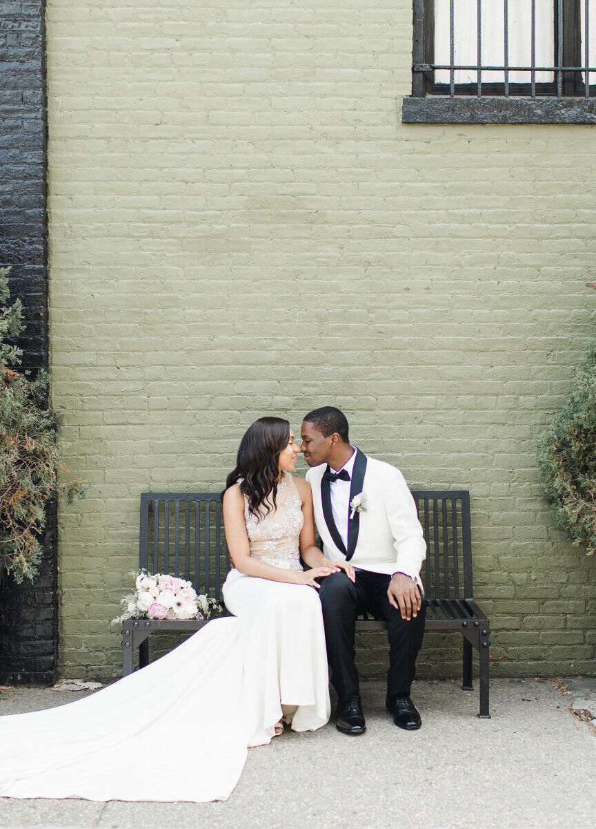 Best Places for a Minimalist Wedding: A bride and groom sitting on a bench in front of The Green Building.