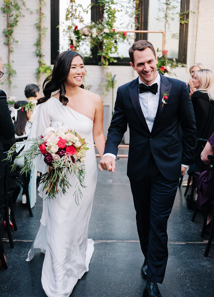 Best Places for a Minimalist Wedding: A smiling bride and groom walking back down the aisle at 501 Union.